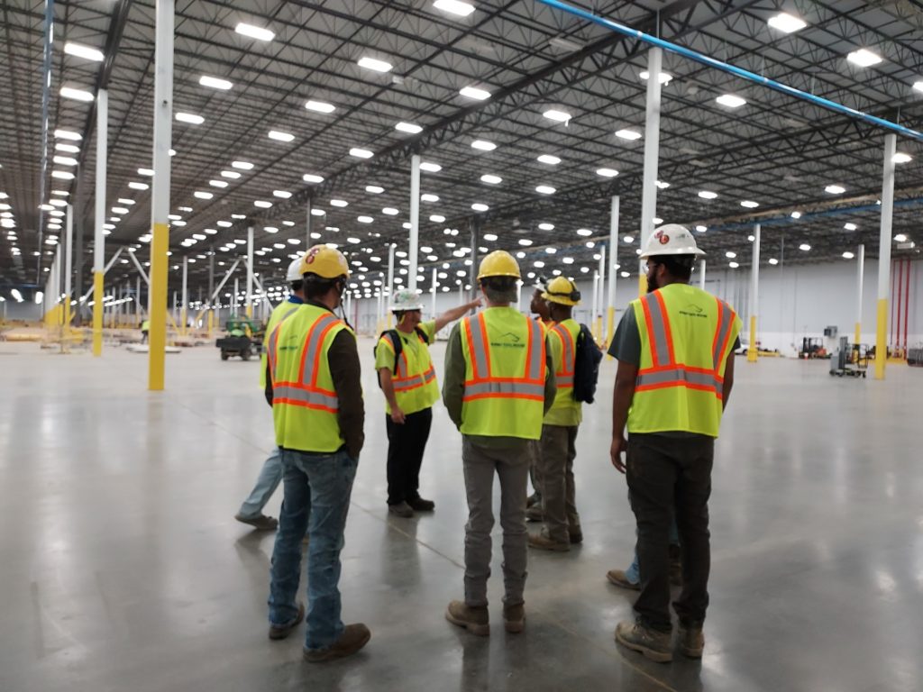 group of people standing with hardhats | Rhino Tool House