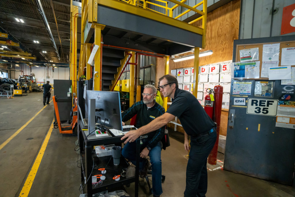 two men operating large piece of machinery | Rhino Tool House